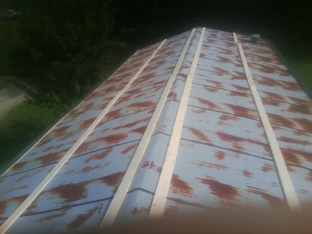 Rusted metal roof panels with new wood purlins before replacement — Storm Damage Roof Repair in Channahon by Roofing Brothers