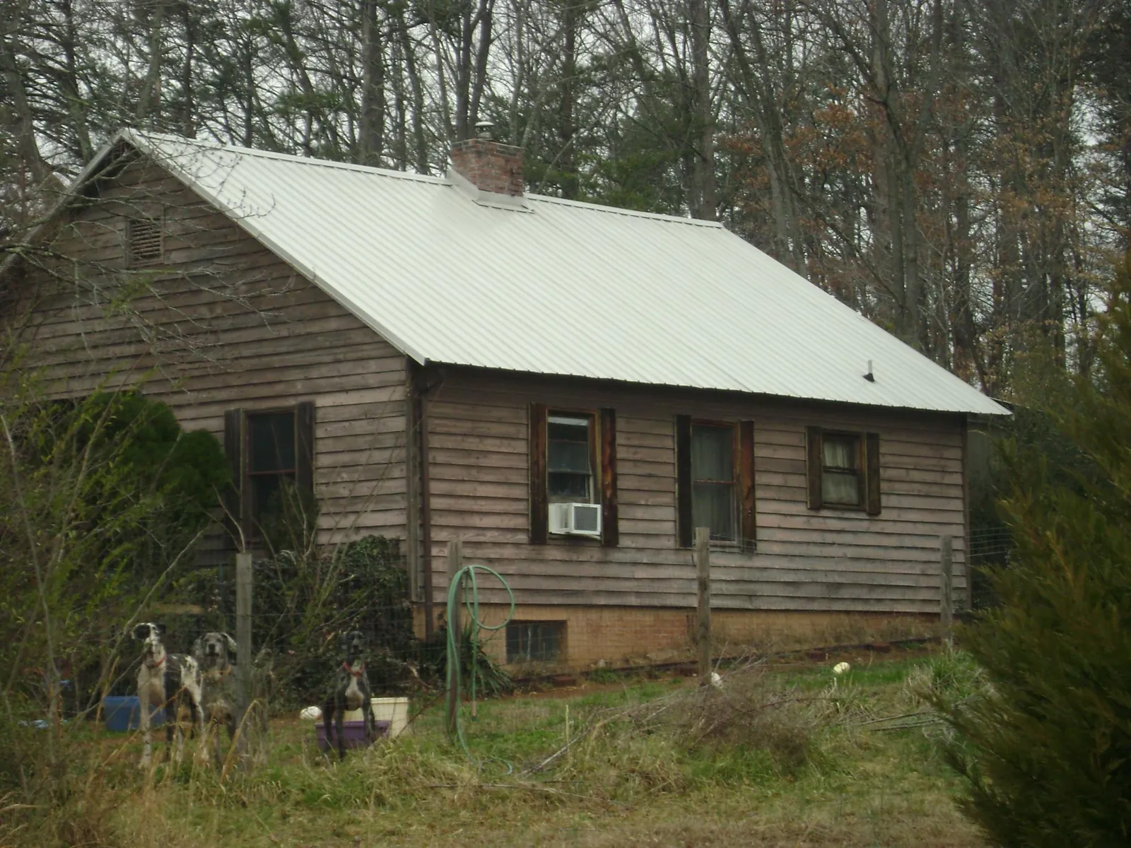 White metal roof on an old wood sided farmhouse, from a Metal Roof Installation job in Channahon
